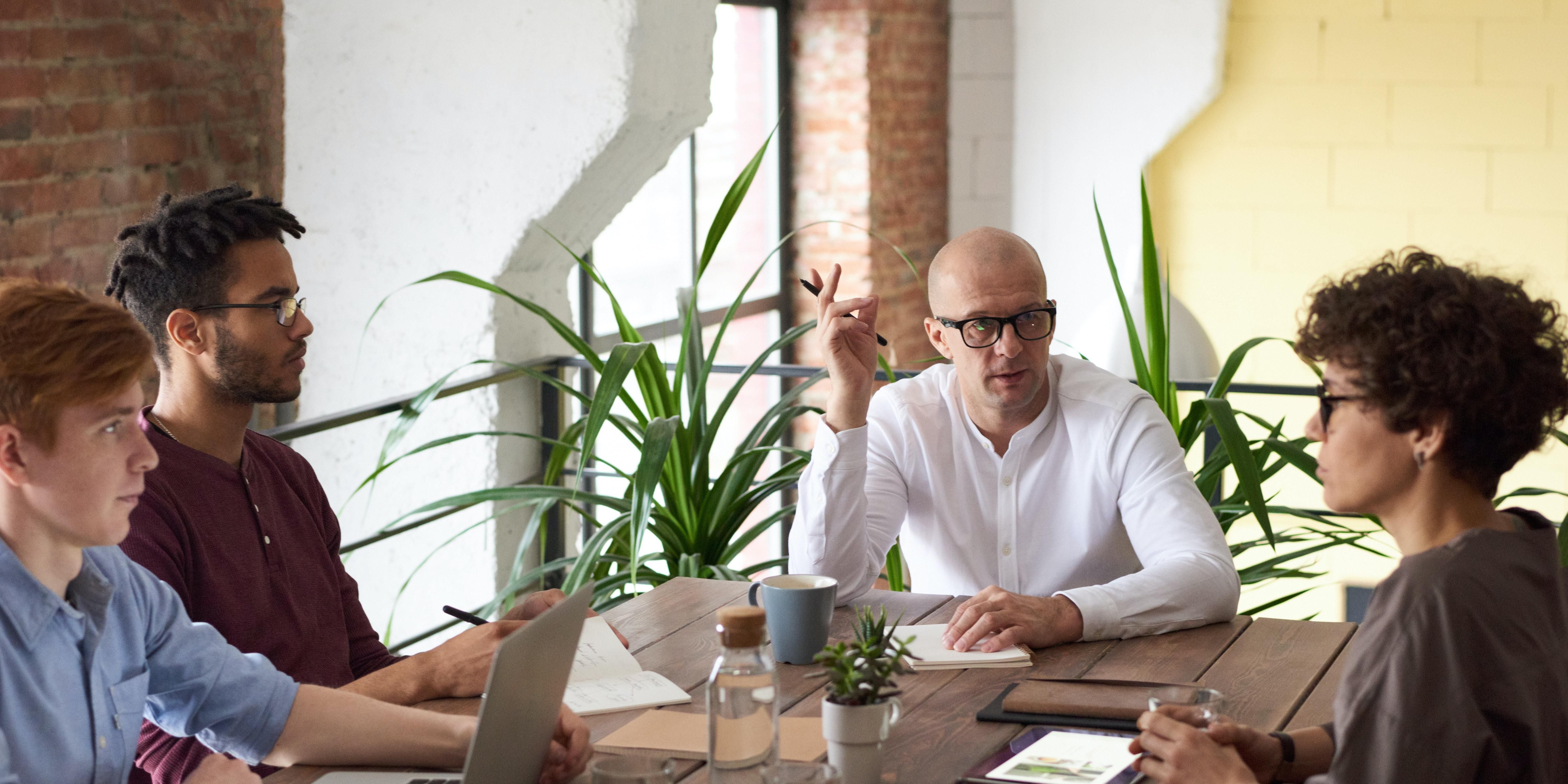 Photo of three people at a leadership meeting